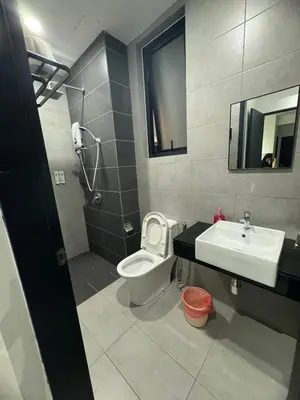 a bathroom with a toilet and a sink and a mirror at 3BR Seaside Oasis Sleeps 10 Chic & Spacious A29 in George Town