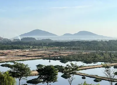 a large body of water with trees and mountains in the background at Brand NEW Modern Cozy Retreats 3BR2B2P for 6 in Batu Kawan