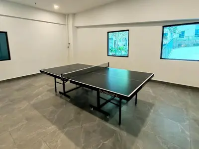 a ping pong table in an empty room with ahibition at Brand NEW Modern Cozy Retreats 3BR2B2P for 6 in Batu Kawan