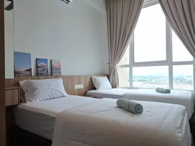 two beds in a hotel room with a large window at Cozy Homestay - Ipoh Garden in Ipoh