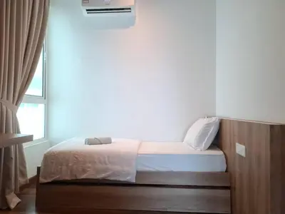 a small bed in a room with a window at Cozy Homestay - Ipoh Garden in Ipoh
