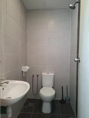 a bathroom with a white toilet and a sink at Cozy Homestay - Ipoh Garden in Ipoh