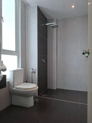 a bathroom with a white toilet and a shower at Cozy Homestay - Ipoh Garden in Ipoh