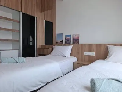 two beds sitting next to each other in a room at Cozy Homestay - Ipoh Garden in Ipoh
