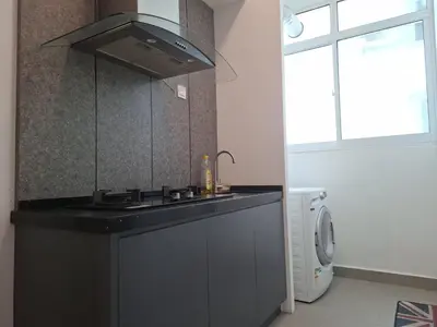 a kitchen with a sink and a stove top oven at Cozy Homestay - Ipoh Garden in Ipoh