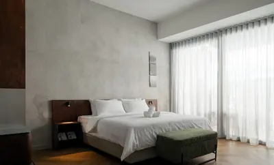a bedroom with a bed with a teddy bear on it at Bishop House in George Town
