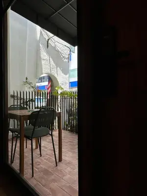 a table and chairs sitting on a patio at Bishop House in George Town