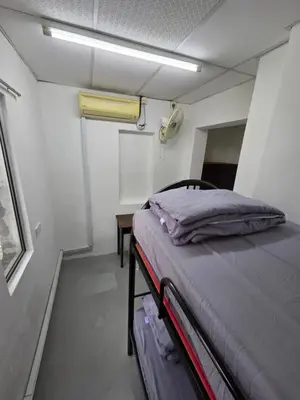 a small room with a bed and a table at Mingle 7 Hostel Georgetown Penang in George Town