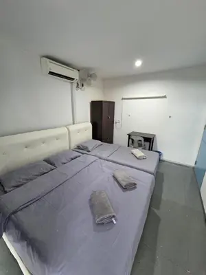 a large bed in a room with two towels on it at Mingle 7 Hostel Georgetown Penang in George Town