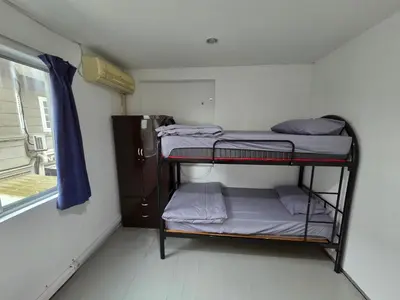 a room with two bunk beds and a window at Mingle 7 Hostel Georgetown Penang in George Town