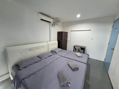 a bedroom with a large bed with two towels on it at Mingle 7 Hostel Georgetown Penang in George Town