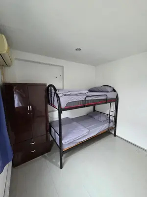 a small room with a bunk bed and a cabinet at Mingle 7 Hostel Georgetown Penang in George Town