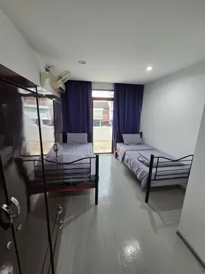 two beds in a room with blue curtains at Mingle 7 Hostel Georgetown Penang in George Town