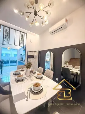 a dining room with a white table and a mirror at GatherLuxe Ipoh, Landed 14Pax, KTV, Kids Room, Baby Cot in Chemor