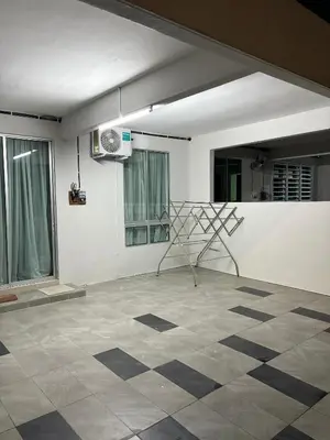 a room with a chair on a tiled floor at Homestay AtinAya in Tanjung Rambutan