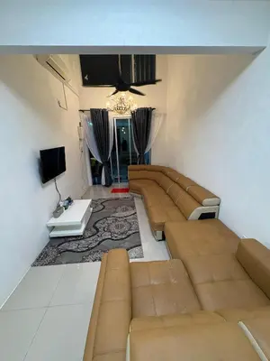 a living room with a couch and a tv at Homestay AtinAya in Tanjung Rambutan