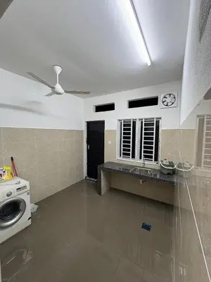 a bathroom with a sink and a washing machine at Homestay AtinAya in Tanjung Rambutan