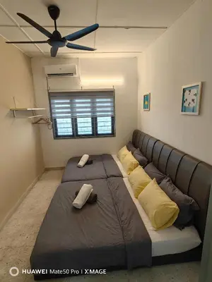 a large bed in a room with a ceiling fan at TL Legend Homestay2 - 4 bedroom single story house in Ipoh