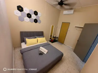 a bedroom with a bed with a towel on it at TL Legend Homestay2 - 4 bedroom single story house in Ipoh