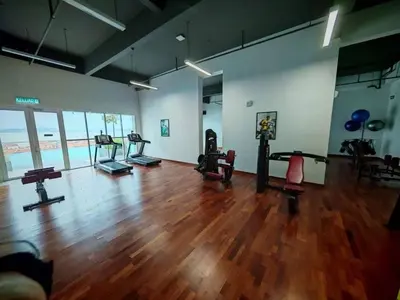 a gym with several exercise equipment in a large room at Middle Room Only in Bayan Lepas Share Space in Bayan Lepas