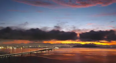 a sunset over the water with a pier at Middle Room Only in Bayan Lepas Share Space in Bayan Lepas