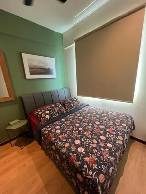 a bedroom with a bed with a floral bedspread at Middle Room Only in Bayan Lepas Share Space in Bayan Lepas