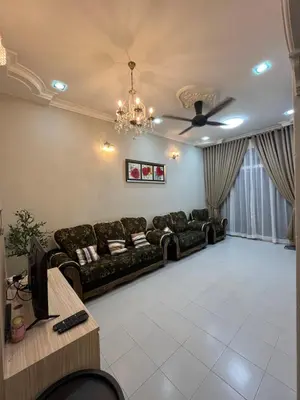 a living room with a couch and a ceiling fan at Family friendly flower homestay-3bedroom in Gerik