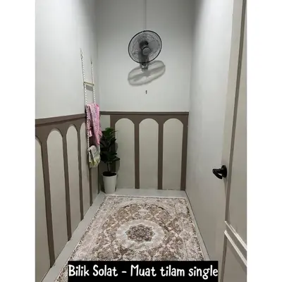 a hallway with a rug and a ceiling fan at Family friendly flower homestay-3bedroom in Gerik