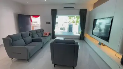 a living room with a couch and a tv at 52 Homestay Pangkor in Pangkor