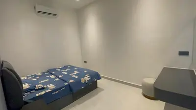 a hospital room with a bed and a chair at 52 Homestay Pangkor in Pangkor