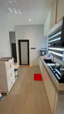a kitchen with a red rug on the floor and a door at 52 Homestay Pangkor in Pangkor