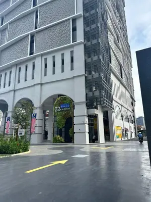 an empty street in front of a large building at Cozy studio with Komtar view at 22 Macalisterz in George Town