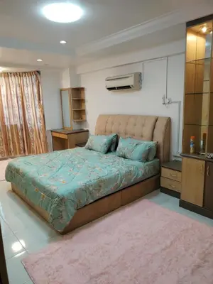 a bedroom with a large bed with blue pillows at Ed 03 lumut Waterfront in Lumut