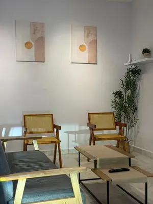 a group of tables and chairs in a room at Muji Homestay, 4 bedrooms, Few mins To Lean Tower by Mr Homestay in Teluk Intan