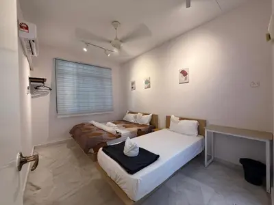 a bedroom with two beds and a window at Muji Homestay, 4 bedrooms, Few mins To Lean Tower by Mr Homestay in Teluk Intan