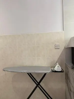 a table in the corner of a bathroom with a phone at Muji Homestay, 4 bedrooms, Few mins To Lean Tower by Mr Homestay in Teluk Intan