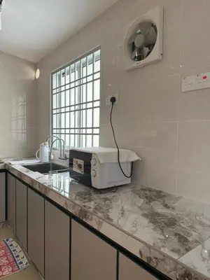 a kitchen with a sink and a microwave on a counter at Muji Homestay, 4 bedrooms, Few mins To Lean Tower by Mr Homestay in Teluk Intan