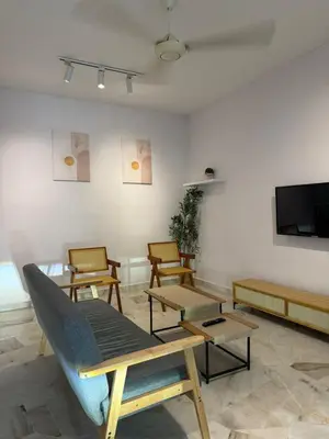 a living room with chairs and a flat screen tv at Muji Homestay, 4 bedrooms, Few mins To Lean Tower by Mr Homestay in Teluk Intan