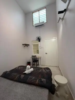 a teddy bear laying on a bed in a room at Muji Homestay, 4 bedrooms, Few mins To Lean Tower by Mr Homestay in Teluk Intan