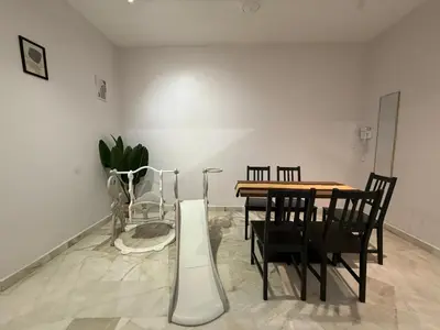a dining room with a table and chairs at Muji Homestay, 4 bedrooms, Few mins To Lean Tower by Mr Homestay in Teluk Intan