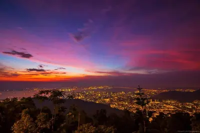 a view of a city from a mountain at sunset at 22 Macalisterz 2025 Georgetown Premium \u9876\u697c\u65e0\u8fb9\u6cf3\u6c60 in George Town