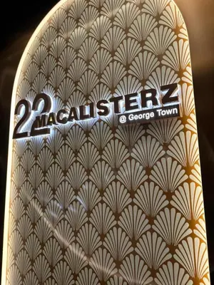 a close up of a book with the words easten at 22 Macalisterz 2025 Georgetown Premium \u9876\u697c\u65e0\u8fb9\u6cf3\u6c60 in George Town