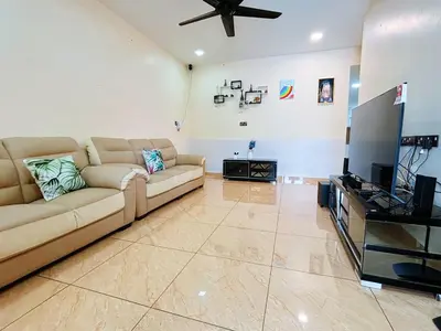 a living room with a couch and a flat screen tv at MiuMiu Homestay in Teluk Intan
