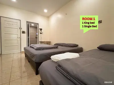 a room with two beds and a sign on the wall at MiuMiu Homestay in Teluk Intan