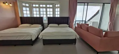 a room with two beds and a couch and a window at A3-6-1Silverpark LuxMountsin view Lifted unit in Bukit Fraser