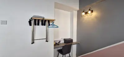a hallway with a desk and a chair in a room at A3-6-1Silverpark LuxMountsin view Lifted unit in Bukit Fraser
