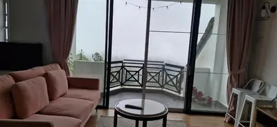 a living room with a couch and a table at A3-6-1Silverpark LuxMountsin view Lifted unit in Bukit Fraser