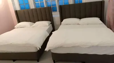 two beds sitting next to each other in a bedroom at A3-6-1Silverpark LuxMountsin view Lifted unit in Bukit Fraser