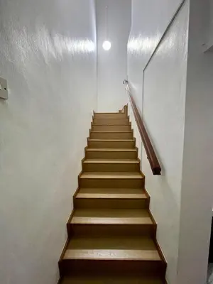 a staircase in a building with wooden steps at Inap by KF in Bayan Lepas