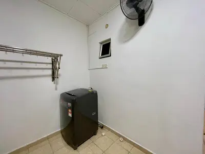 a room with a trash can and a fan on the wall at Inap by KF in Bayan Lepas